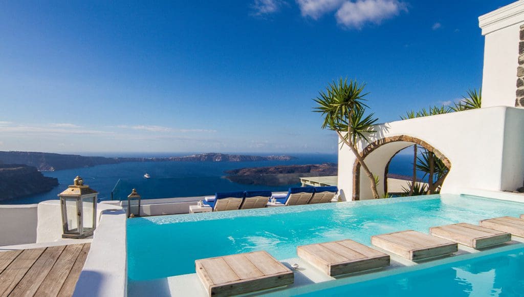 Iconic Santorini Hotel pool terrace view with sea in background
