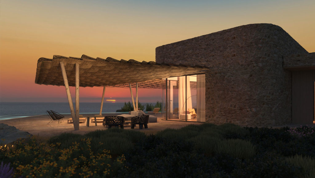 Petrothalassa Villas covered outdoor lounge with a sea view at night