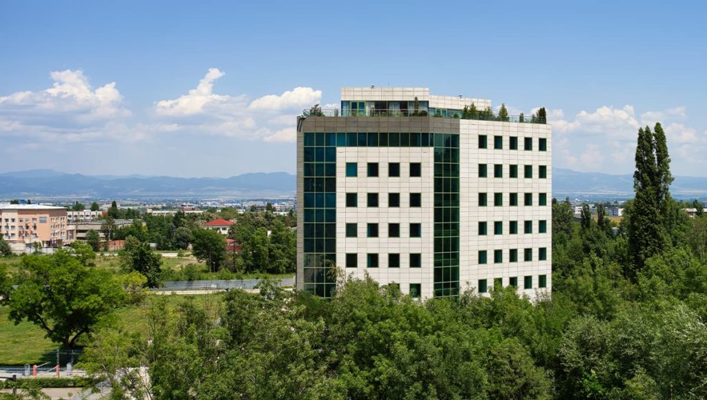 Prizma Offices building with surrounding trees and Sofia view in background