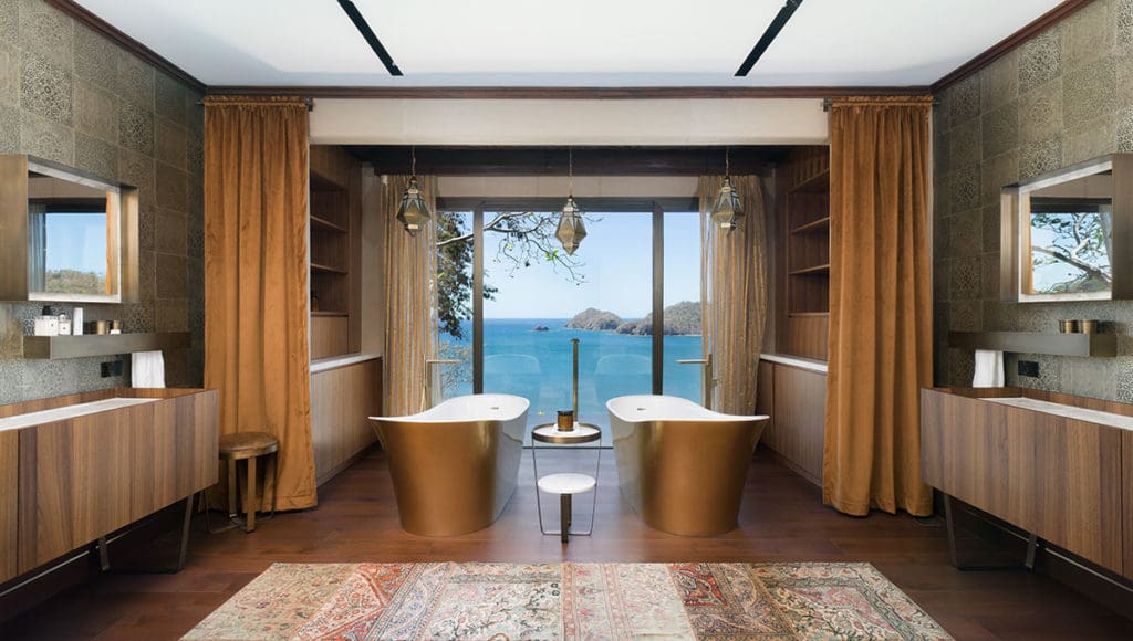 Two bathtubs in a large bathroom with a sea view in The Hive Residence